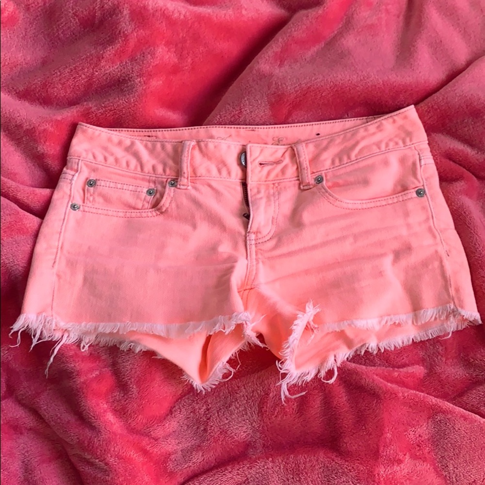 Peach frayed jean shorts